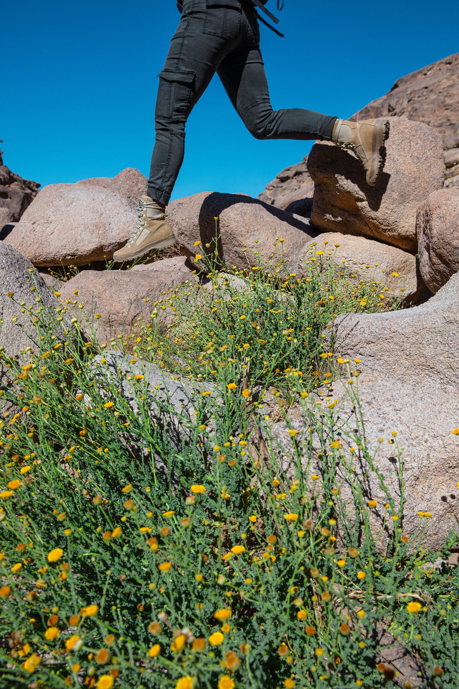 a man with a backpack is running on rocks